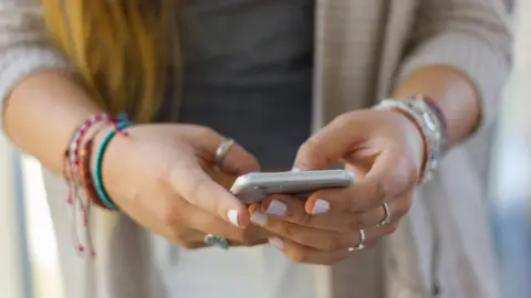 Getty Images Woman using mobile phone