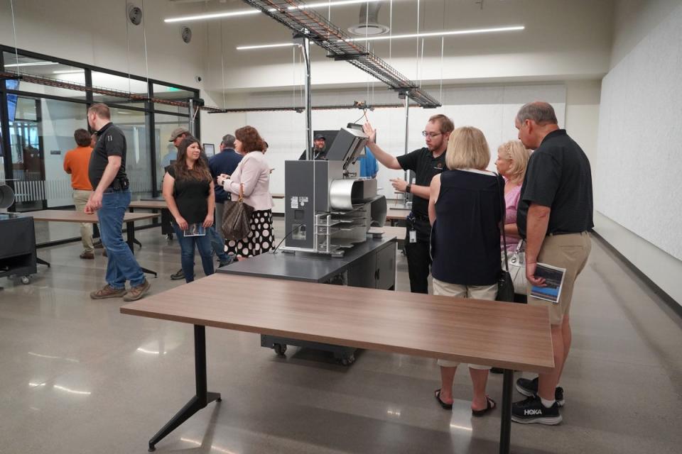 In Pinal County, Arizona, a wall of windows — dubbed the “fishbowl” — allows onlookers a 360-degree view to easily watch ballots being counted. People are seen touring the area during an open house (Pinal County)