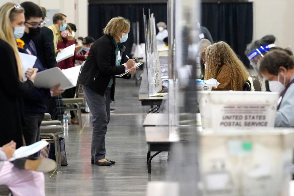 Recount observers watch ballots during a Milwaukee hand recount of Presidential votes at the Wisconsin Center, Nov. 20, 2020, in Milwaukee, Wisconsin. Counties across the country are implementing new measures to promote transparency ahead of the 2024 presidential election (Copyright 2020 The Associated Press. All rights reserved.)