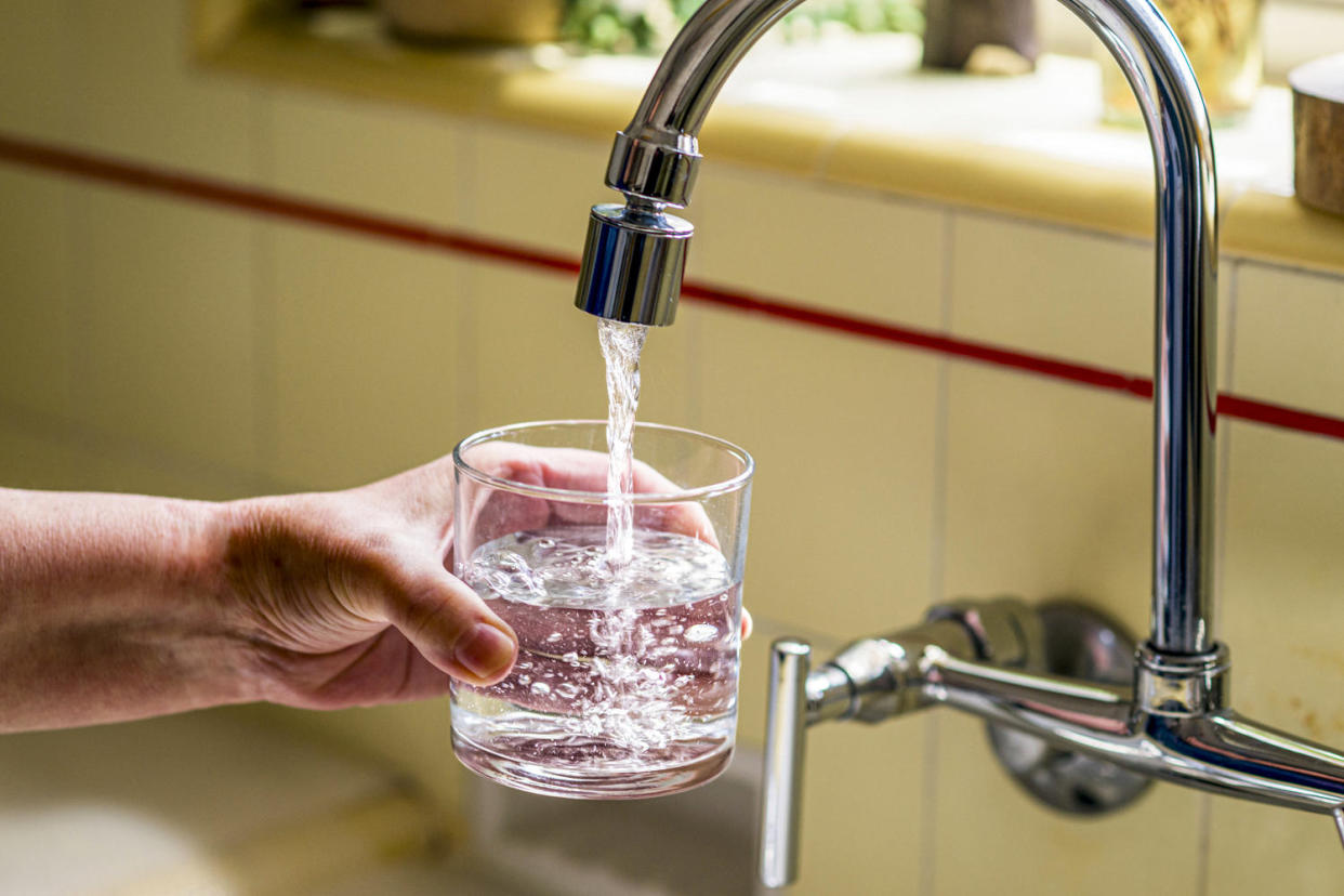 Pouring a glass of water from a kitchen faucet. (Leonard Ortiz / MediaNews Group via Getty Images)