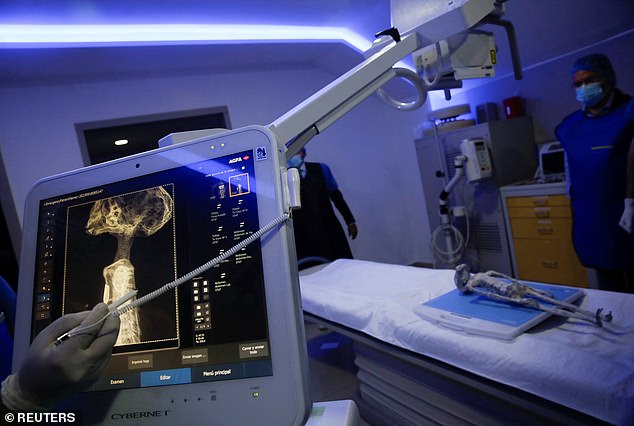 Radiologist technician Guillermo Ramirez examines an x-ray of one of Maussan's 'Nazca mummy' specimens (above) at Noor Clinic, in Huixquilucan, Mexico on September 18, 2023