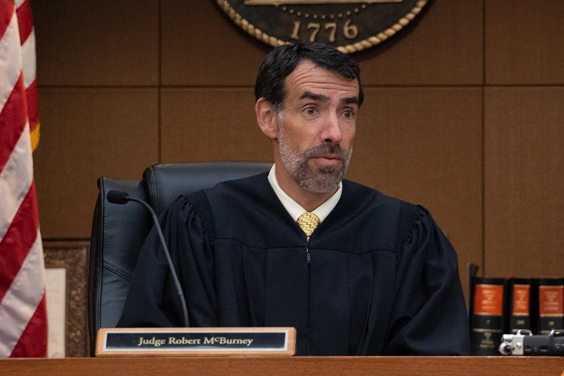 Fulton County Superior Court Judge Robert McBurney receives documents from County Court Clerk Che Alexander on August 14, 2023 in Atlanta, Georgia. District Attorney Fani Willis has been bringing evidence before a grand jury, which today handed up indictments on alleged attempts to overturn the 2020 election results in the state, though it wasn't immediately clear if former President Donald Trump was named. (Photo by Megan Varner/Getty Images)