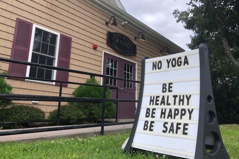 A message board tells residents that yoga classes have been canceled on Wednesday, July 15, 2020, at the Grange Community Center in Hope Valley, R.I. Could these be the good old days? Futurists and others say people may actually look back at 2020 with nostalgia if the coronavirus pandemic lingers and health and economic concerns worsen. (AP Photo/William J. Kole)