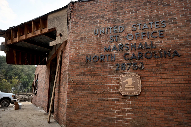 A view of a United States Post Office, damaged by flooding from Hurricane Helene, on October 3, 2024 in Marshall, North Carolina. State election officials will face a challenge ensuring voting access to those who will vote by mail in the November presidential elections following widespread flooding in Western North Carolina. At least 200 people were killed in six states in the wake of the powerful hurricane which made landfall as a Category 4. President Joe Biden took an aerial tour of the devastated region yesterday and ordered the deployment of 1,000 active duty U.S. soldiers to assist with storm relief efforts and reinforce the North Carolina National Guard. (Photo by Mario Tama/Getty Images)