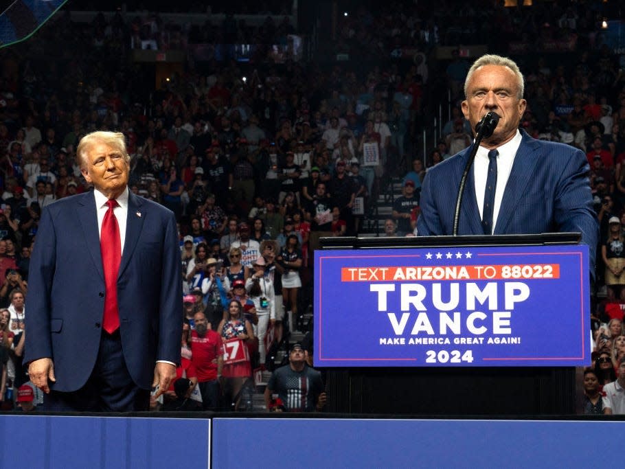 RFK Jr. speaks at a Trump rally as Trump watches.