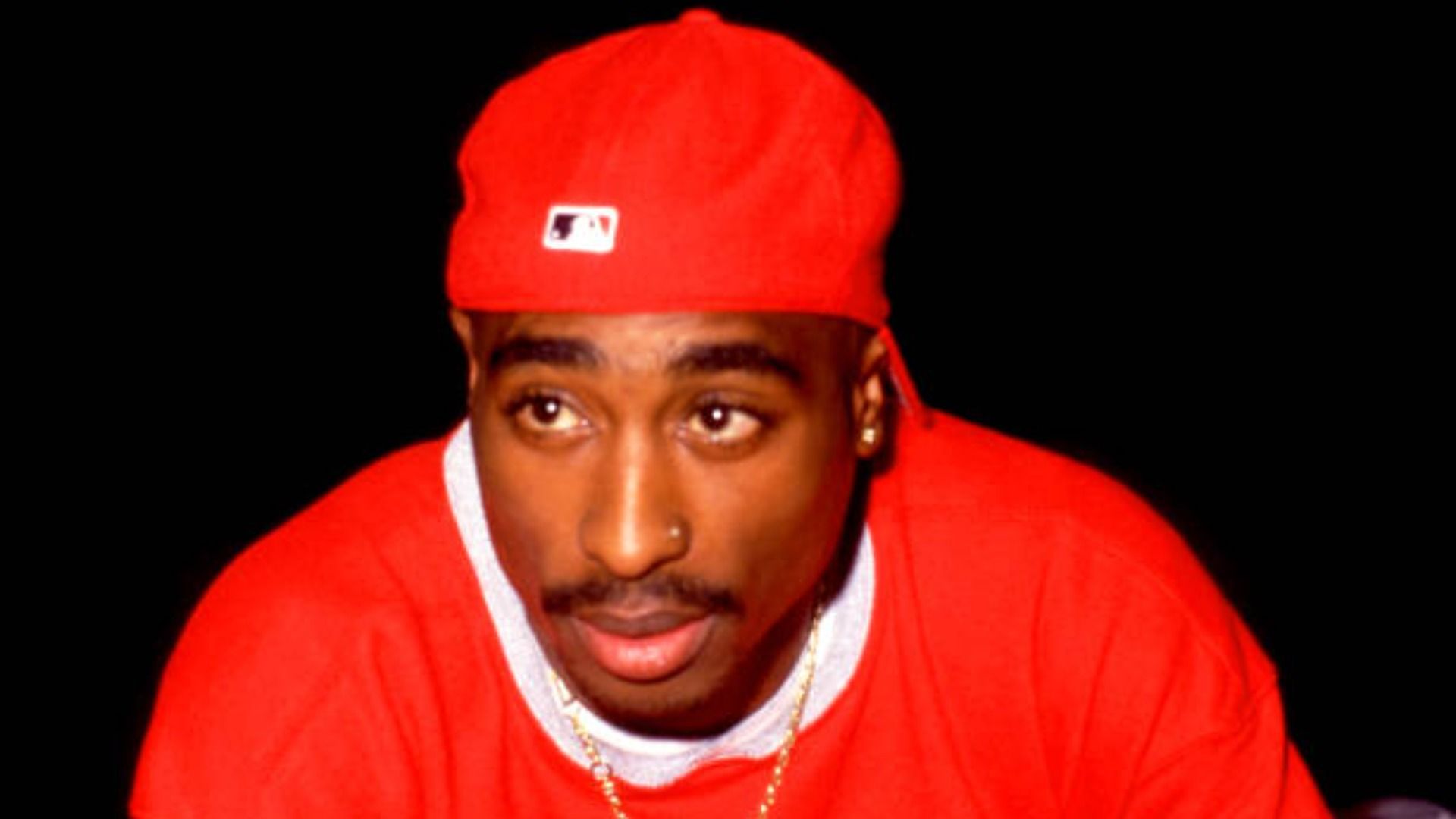 Tupac Shakur poses for a portrait / Image Source: Getty