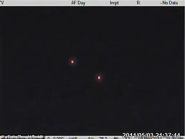 Many Reddit users initially thought the dots were flares, but the camera later switches from FLIR mode to normal vision - revealing that the orbs were glowing multi-colored dots that rigidly moved in a spatial relationship with each other