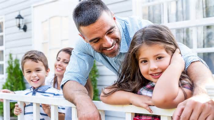 happy family outside home middle class concept_iStock-1311456080