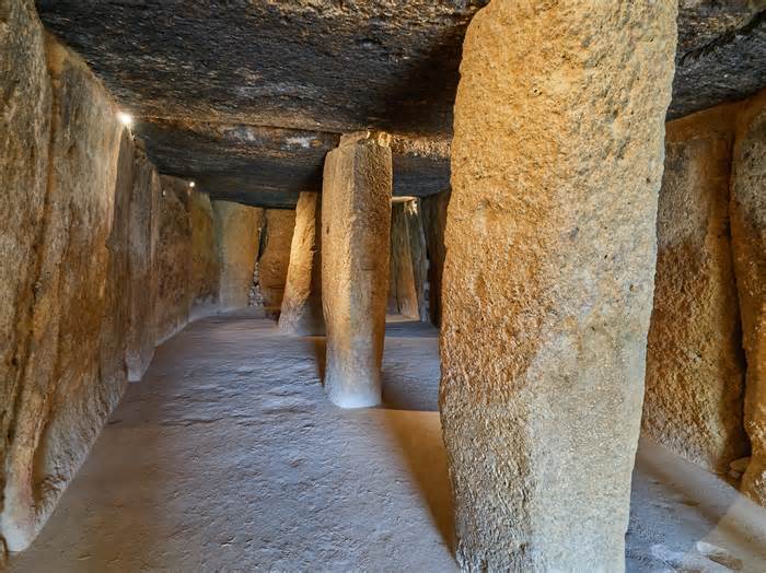 The interior of the Menga dolmen features large stone columns that help support the structure.