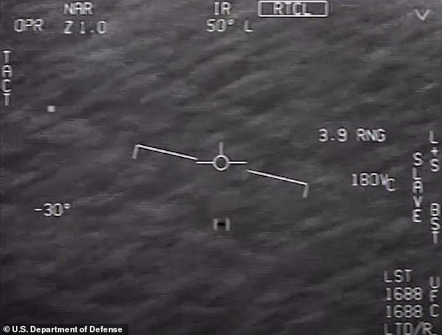 Public interest in UFOs heightened in 2017 with the leak of three Navy pilot infrared videos that captured 'unidentified anomalous phenomena' (UAP). Above, a still from one of these videos, 'Go Fast,' which the Pentagon tried to explain this week as a prosaic object blowing in the wind