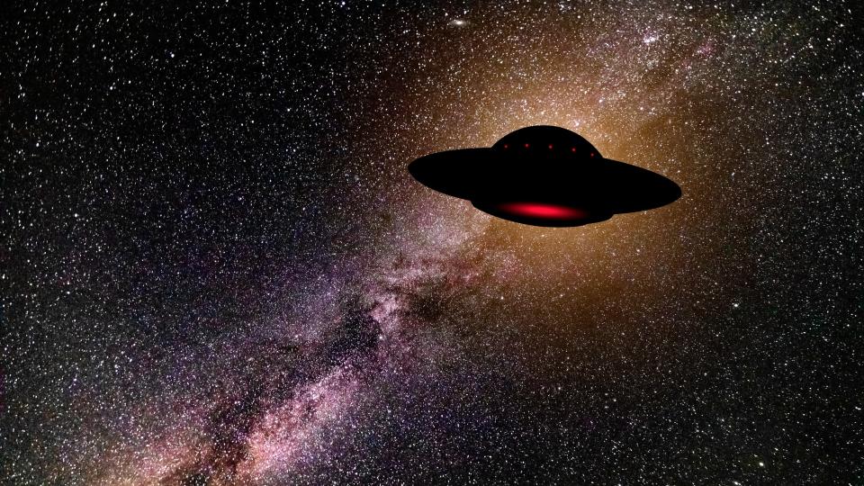  An illustration of a lonely flying saucer against the dark backdrop of space. 