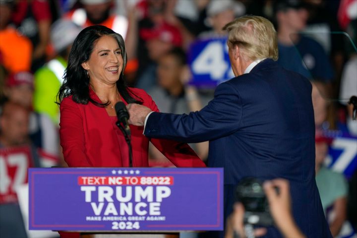 Donald Trump welcomes Tulsi Gabbard during a campaign rally at Greensboro Coliseum on Oct. 22, 2024, in Greensboro, North Carolina.