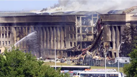 Getty Images Smoke pours from the Southwest E-ring of the Pentagon building September 11, 2001 in Arlington, Virginia after a hijacked plane crashed into the building and set off a huge explosion.