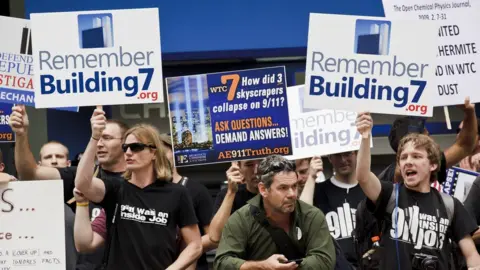 Getty Images 9/11 conspiracy theorists protest outside the memorial service at the World Trade Center construction site marking the 10th anniversary of the attacks on September 11, 2001.