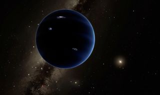 a dark blue planet seen against a starry background