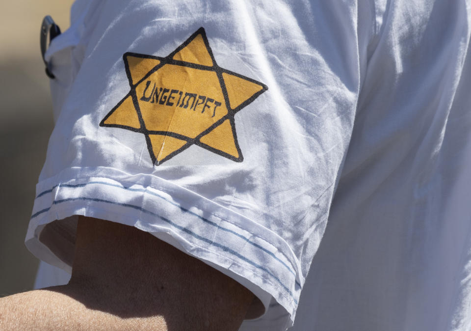 A man is seen wearing a yellow star of David with the the word &quot;Unvaccinated&quot; on his sleeve at a demonstration against coronavirus restrictions in Frankfurt, Germany on May 16, 2020. Some protesters in Germany, who've compared the current government's coronavirus restrictions to Nazi policies, have begun displaying such patches or arm bands, like the ones European Jews were forced to wear during the Holocaust. (Boris Roessler/picture alliance via Getty Images)