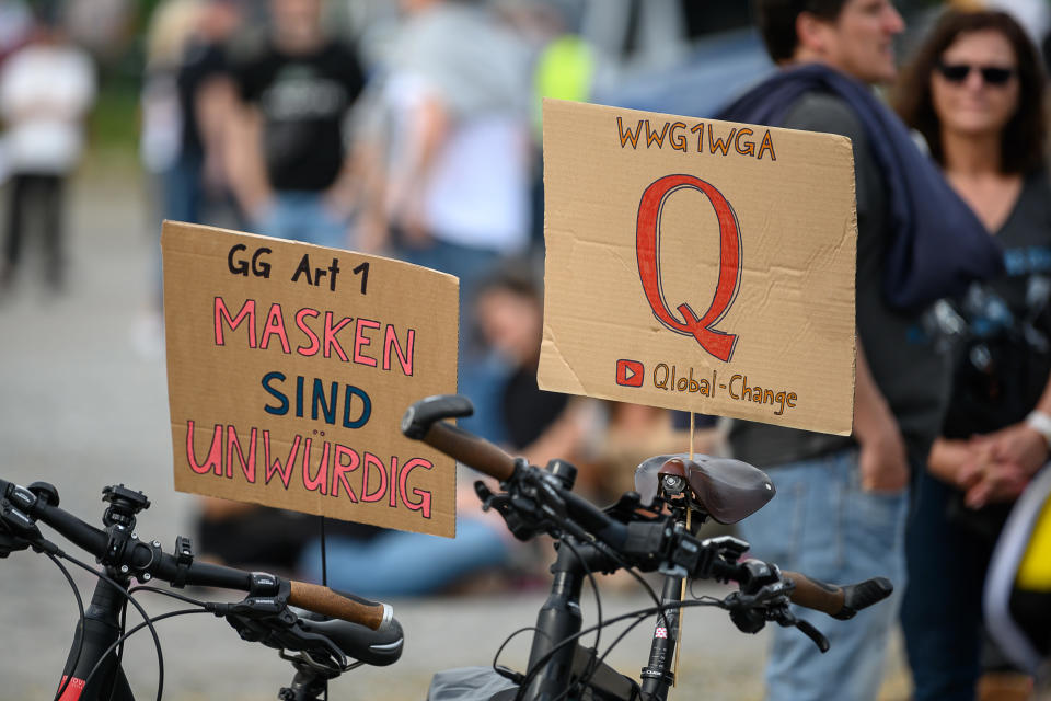 Signs referencing the QAnon conspiracy theory