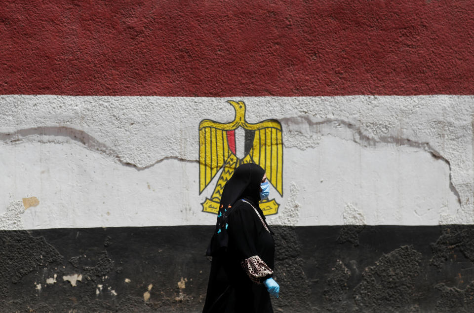 A woman wearing a protective face mask and gloves