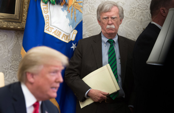 Image: National Security Adviser John Bolton stands alongside President Donald Trump as he speaks during a meeting in the Oval Office.