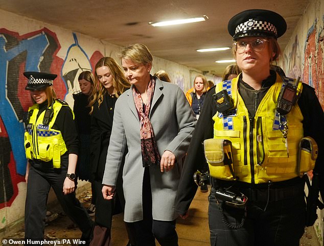 Yvette Cooper - pictured meeting police - has rejected the findings of a controversial Home Office review