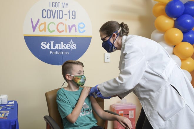 Dr. Jennifer Janco, chief of pediatrics for St. Luke's University Health Network, gives an immunization to her son, August Mascitti. The health network urges parents and guardians to get their children vaccinated for childhood illnesses such as polio, as well as COVID-19 and the flu.