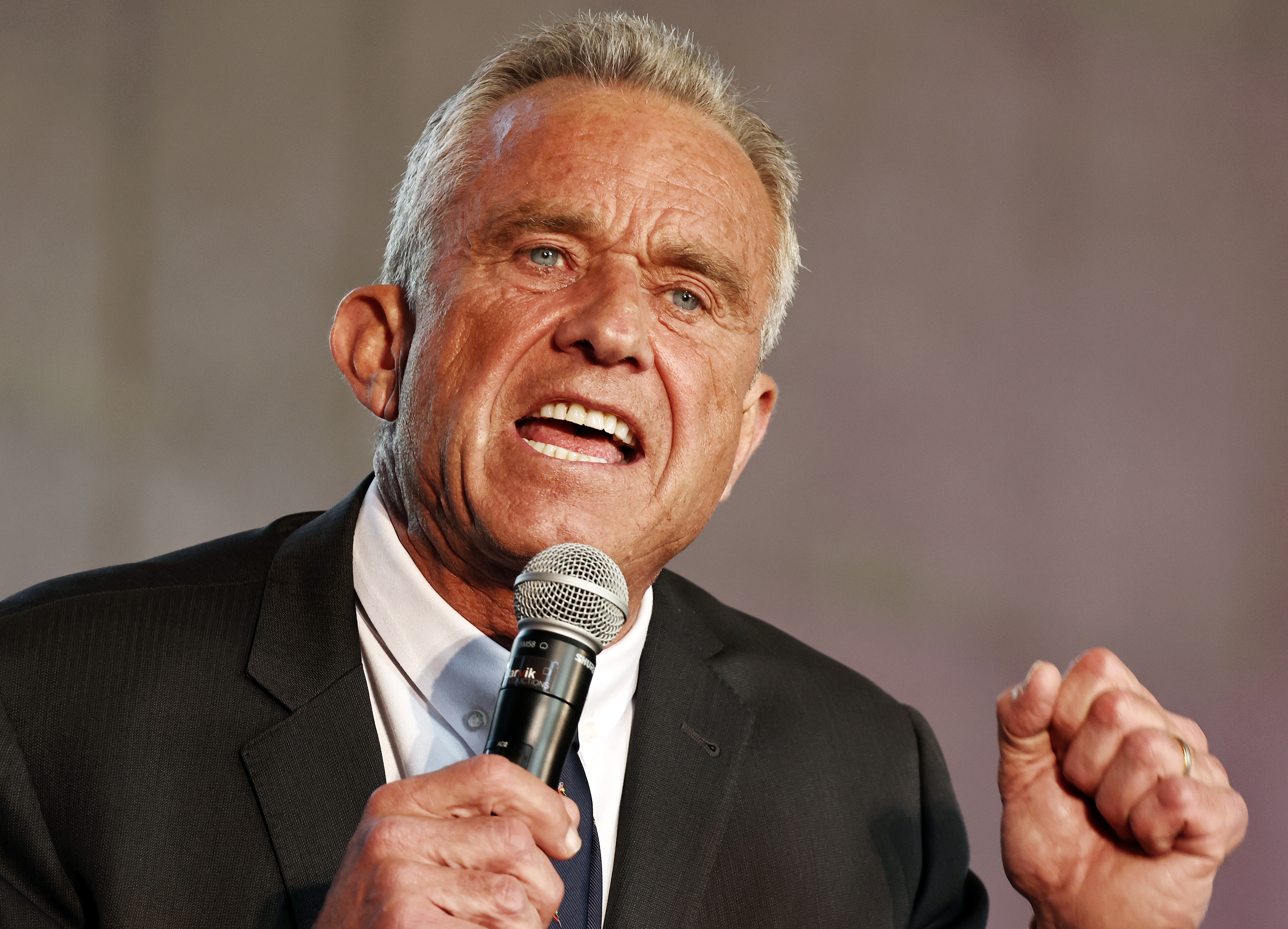 Robert F. Kennedy Jr. speaking at a microphone.