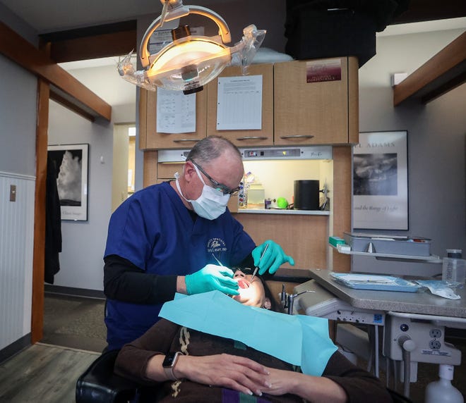 Dr. David Houpt performs a dental checkup for a patient at his Old Town Dental office in Silverdale. Houpt, a member of the Kitsap Dental Society, said the greatest impact of a lack of fluoridated water is on residents who don't regularly see a dentist or use quality dental care items.